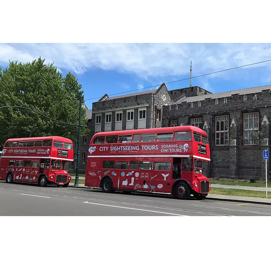 Hassle Free Tours Soaring Kiwi red double decker buses parked outside Christ College